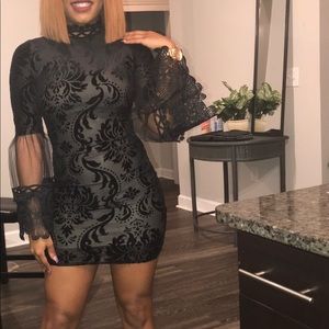 Black fitted sheet and lace long sleeve dress.